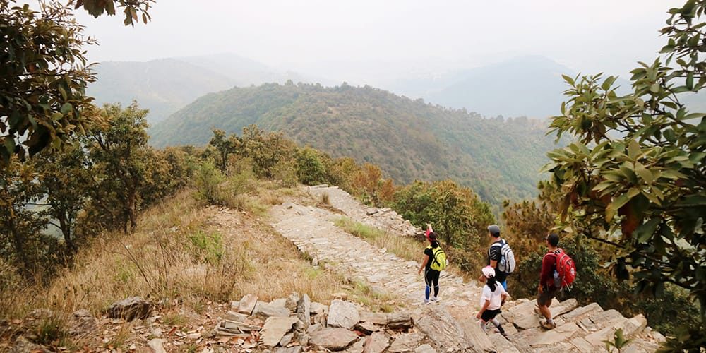 Hikers on the stone ridge trail to Champa Devi above the Kathmandu Valley