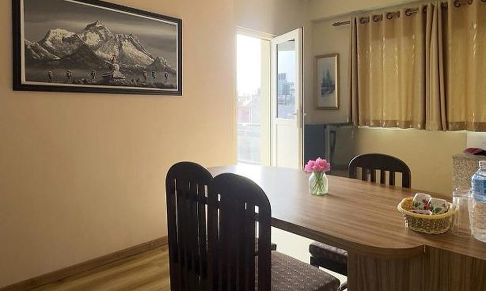 Dining table by the balcony window, a spot to work over free WiFi at House of Forrest